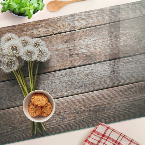Schneidebrett glas Löwenzahnblüten auf Holzgrund