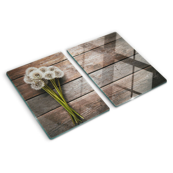 Schneidebrett glas Löwenzahnblüten auf Holzgrund