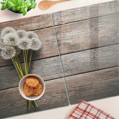 Schneidebrett glas Löwenzahnblüten auf Holzgrund