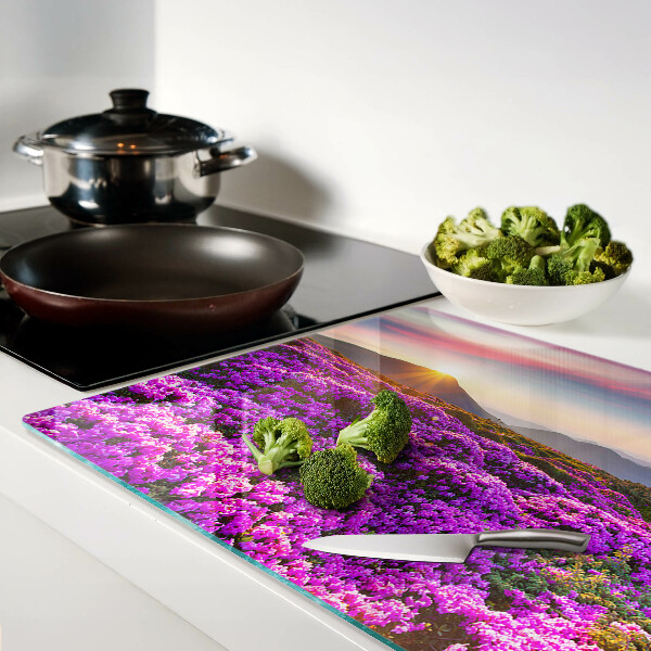 Schneidebrett Glas mit Motiv einer Blumenlandschaft bei Sonnenuntergang
