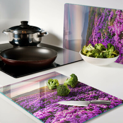 Schneidebrett Glas mit Motiv einer Blumenlandschaft bei Sonnenuntergang