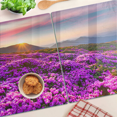 Schneidebrett Glas mit Motiv einer Blumenlandschaft bei Sonnenuntergang