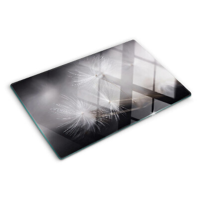 Schneidebrett glas Flauschige Löwenzahnblüten vor dem Fensterhintergrund