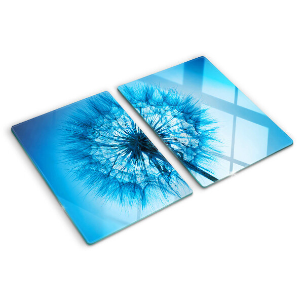 Glas-Schneidebrett mit Löwenzahn-Motiv auf blauem Hintergrund