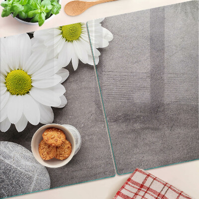 Schneidebrett glas Blumen und Steine im Hintergrund