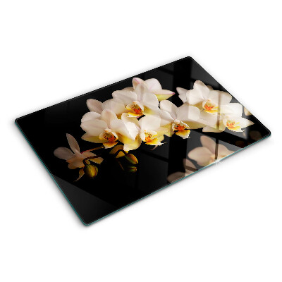 Glas schneidebrett Orchideen auf schwarzem Hintergrund