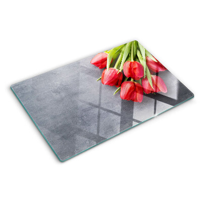 Glas-Schneidebrett mit Tulpenmotiv auf grauem Hintergrund
