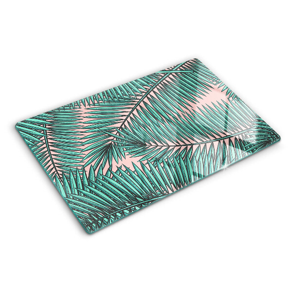 Glas schneidebrett Palmenblätter auf rosa Hintergrund