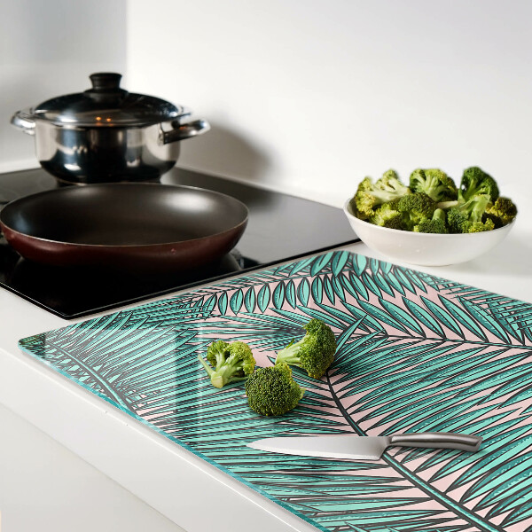 Glas schneidebrett Palmenblätter auf rosa Hintergrund