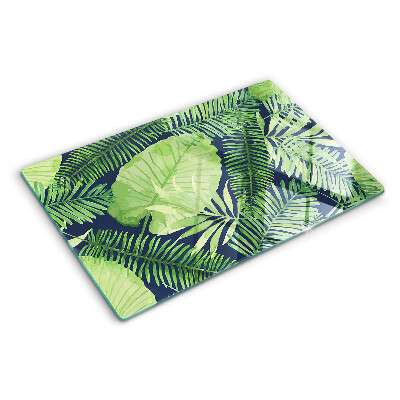 Glas schneidebrett Tropische Blätter auf dunklem Hintergrund