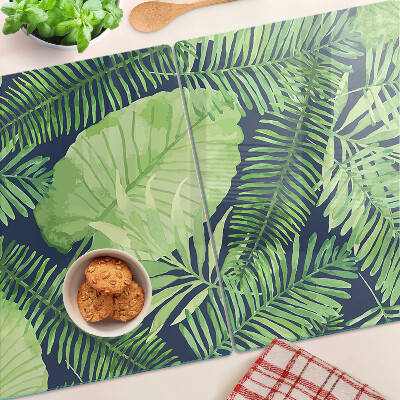 Glas schneidebrett Tropische Blätter auf dunklem Hintergrund