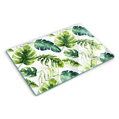 Schneidebrett mit Monstera‑Blättern in Grüntönen