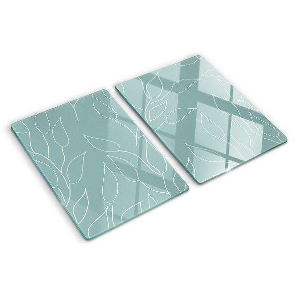 Schneidebrett Glas mit Motiv von Blättern im Hintergrund