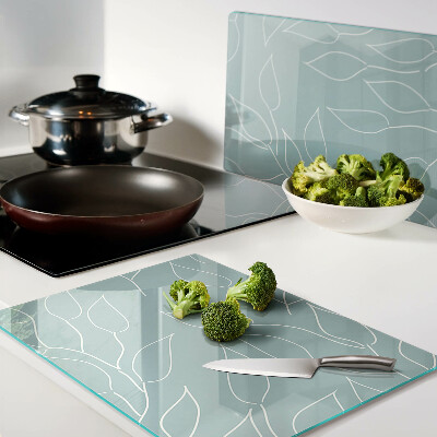 Schneidebrett Glas mit Motiv von Blättern im Hintergrund