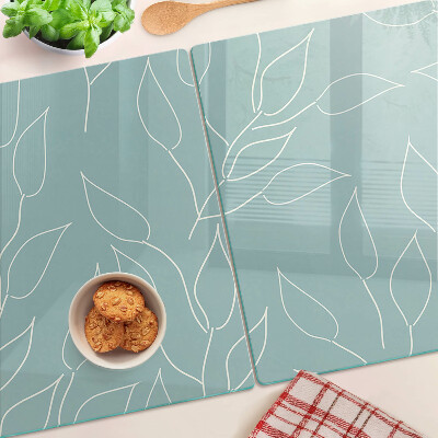 Schneidebrett Glas mit Motiv von Blättern im Hintergrund