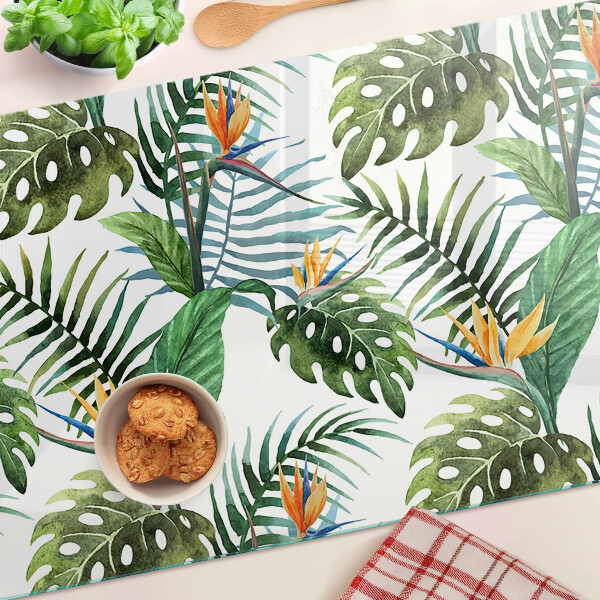 Schneidebrett Glas mit tropischen Blättern und Blüten als Dekor