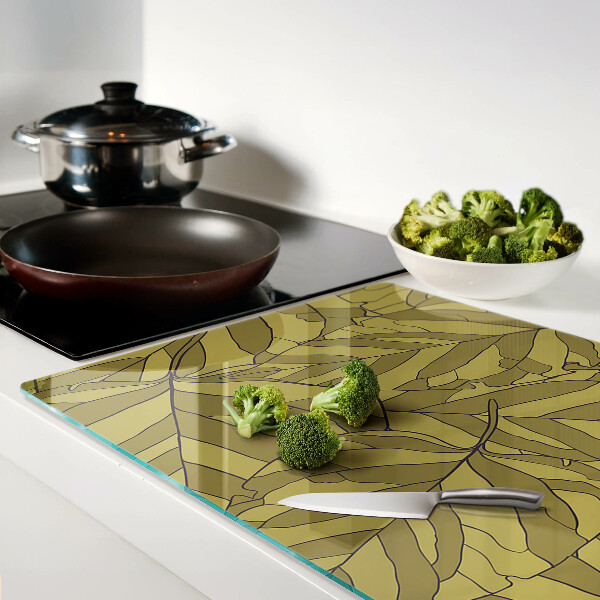 Schneidebrett mit Blattmotiv in Goldtönen