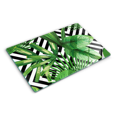 Schneidebrett mit Motiv tropischer Blätter auf gestreiftem Hintergrund