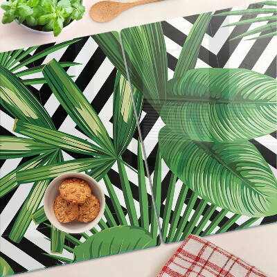Schneidebrett mit Motiv tropischer Blätter auf gestreiftem Hintergrund