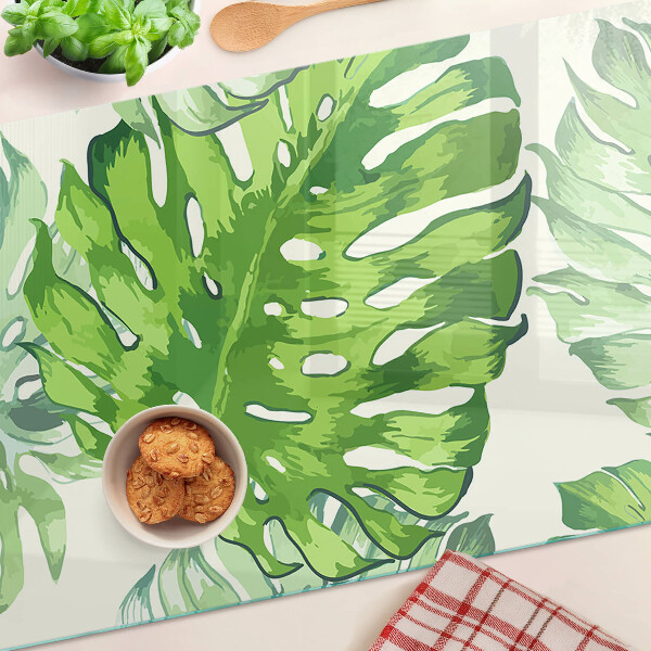 Schneidebrett Monstera-Blätter auf hellem Hintergrund