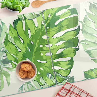 Schneidebrett Monstera-Blätter auf hellem Hintergrund