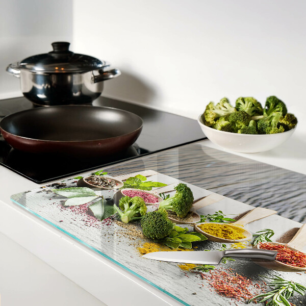 Glas-Schneidebrett mit Motiv aus Gewürzen und Kräutern