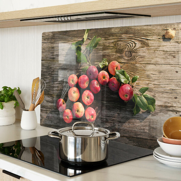 Glas-Schneidebrett mit Motiv von Äpfeln auf Holzgrund