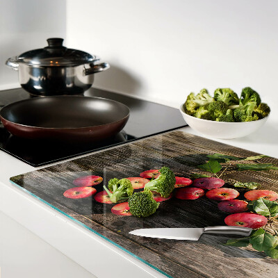 Glas-Schneidebrett mit Motiv von Äpfeln auf Holzgrund