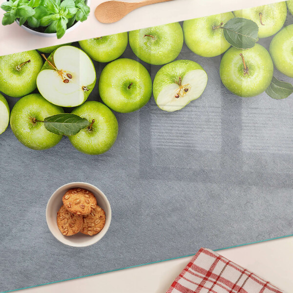 Schneidebrett mit Motiv grüne Äpfel auf grauem Untergrund