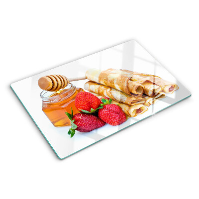 Glas schneidebrett Pfannkuchen mit Honig und Erdbeeren