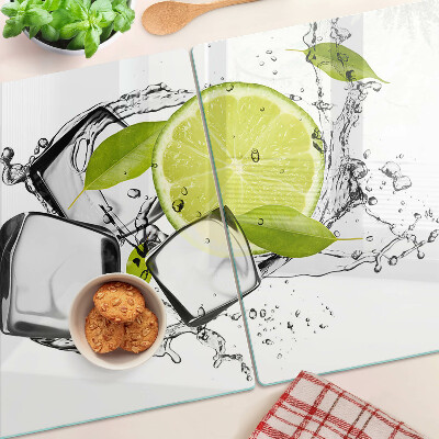 Glas-Schneidebrett mit Motiv einer Zitrone auf Eis und Blättern