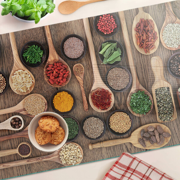 Glas schneidebrett Gewürze und Kräuter in Löffeln