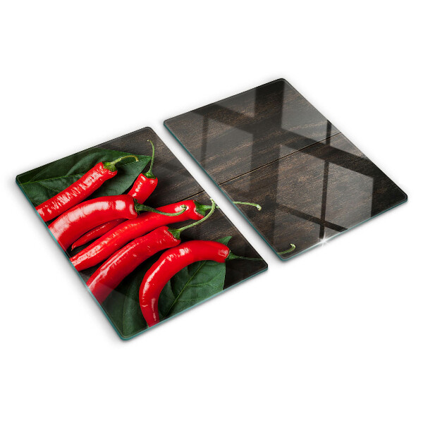 Glas-Schneidebrett mit Chilischoten auf Holzgrund