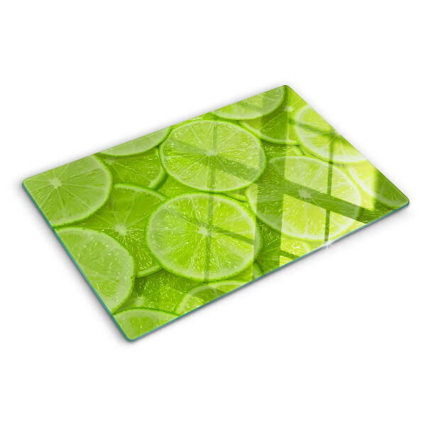 Schneidebrett mit Motiv von Limettenscheiben auf grünem Hintergrund