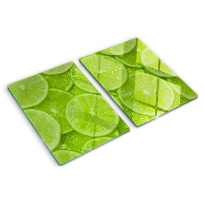Schneidebrett mit Motiv von Limettenscheiben auf grünem Hintergrund