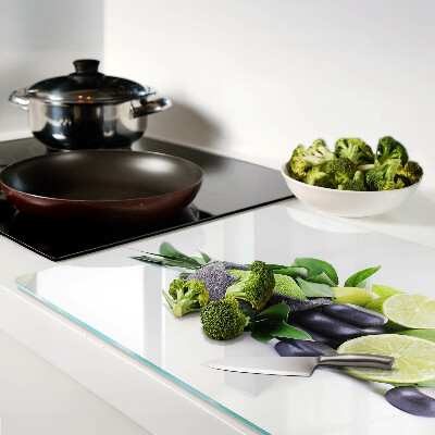 Glas-Schneidebrett mit Motiv aus Zitronen und Trauben auf grünem Hintergrund