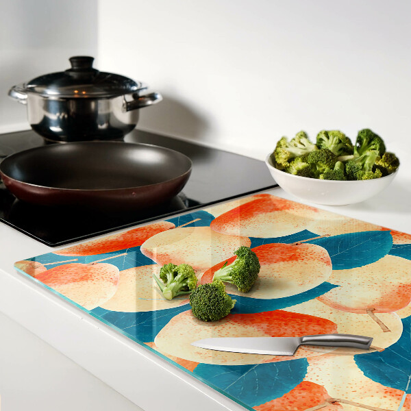 Schneidebrett Glas mit einem Motiv von Pfirsichen vor einem Blätterhintergrund