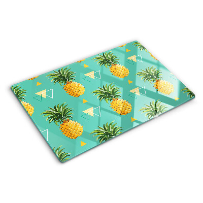 Glas-Schneidebrett mit dem Motiv einer Ananas auf türkisfarbenem Hintergrund
