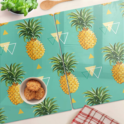 Glas-Schneidebrett mit dem Motiv einer Ananas auf türkisfarbenem Hintergrund