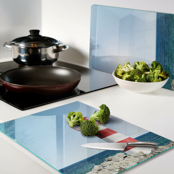 Glas-Schneidebrett mit Motiv eines Leuchtturms über dem Meer