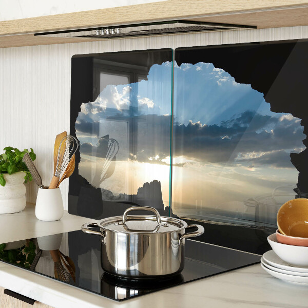 Glas-Schneidebrett mit Motiv eines Sonnenuntergangs hinter Wolken