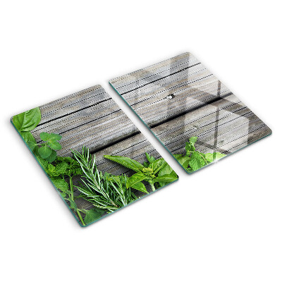 Glas-Schneidebrett mit Motiv grüner Kräuter auf Holzuntergrund