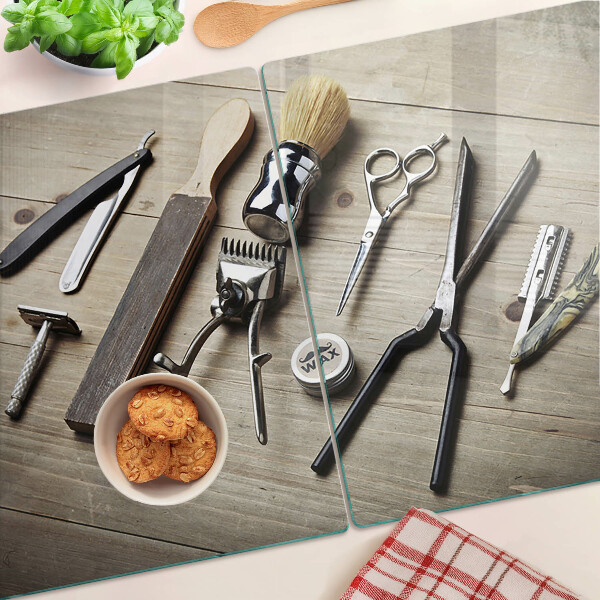 Glas-Schneidebrett mit Friseurwerkzeugen auf Holzoptik