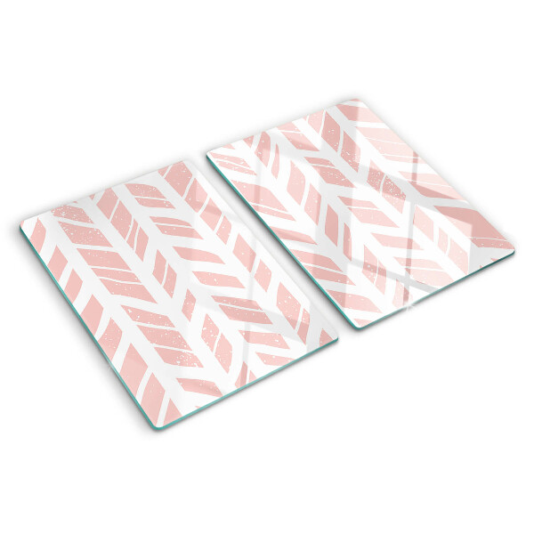 Glas-Schneidebrett mit Blättern in rosafarbenem Ton