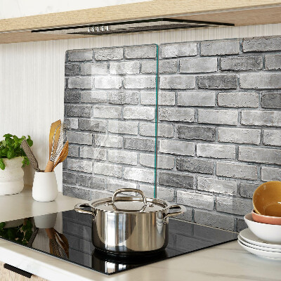 Schneidebrett mit Motiv einer Backsteinmauer in Grautönen