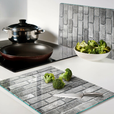 Schneidebrett mit Motiv einer Backsteinmauer in Grautönen