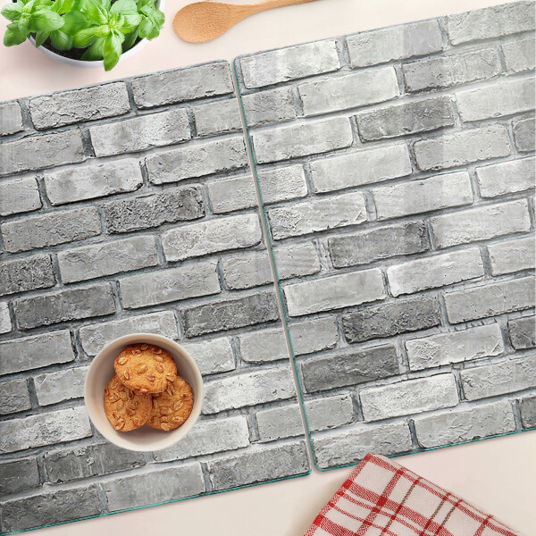 Schneidebrett mit Motiv einer Backsteinmauer in Grautönen