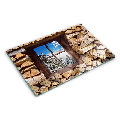 Glas-Schneidebrett mit Motiv einer Winterlandschaft, sichtbar durch ein Fenster