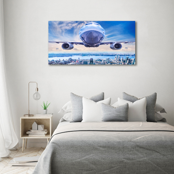 Bild auf Acrylglas Ein Flugzeug über der Stadt