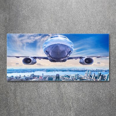 Bild auf Acrylglas Ein Flugzeug über der Stadt